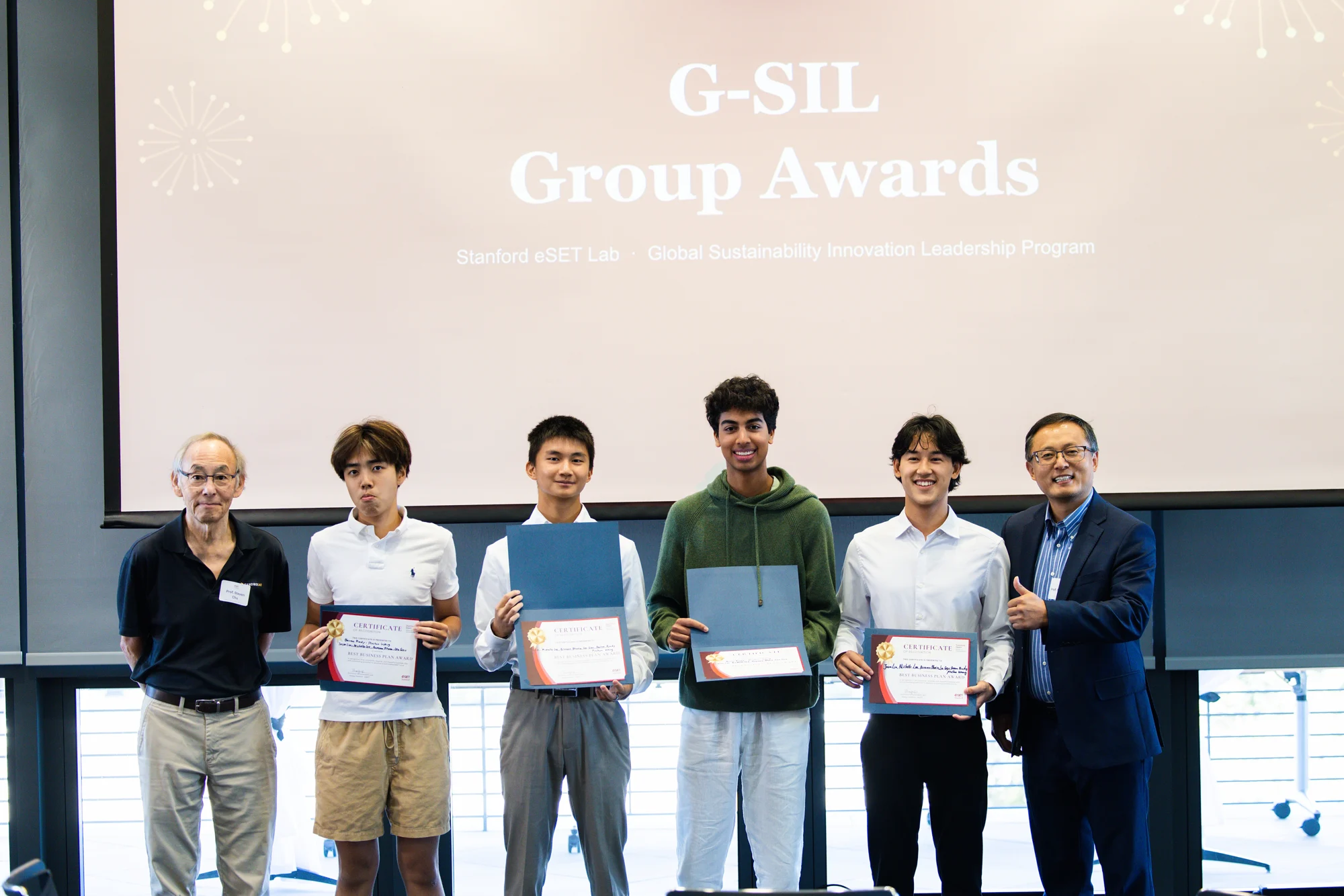 Students holding certificates during the G-SIL group awards