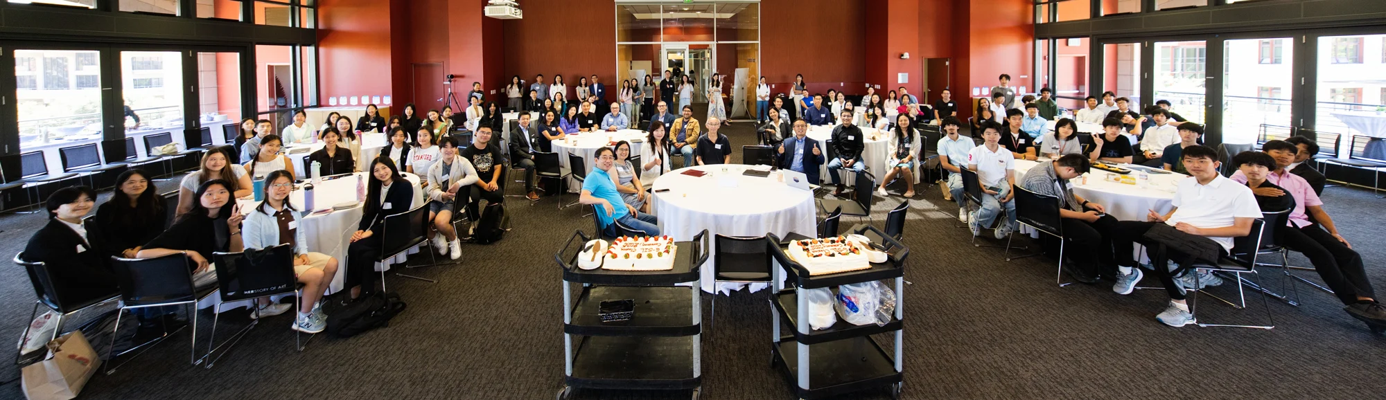 A panoramic view of students, families, educators, and guests at the closing celebration