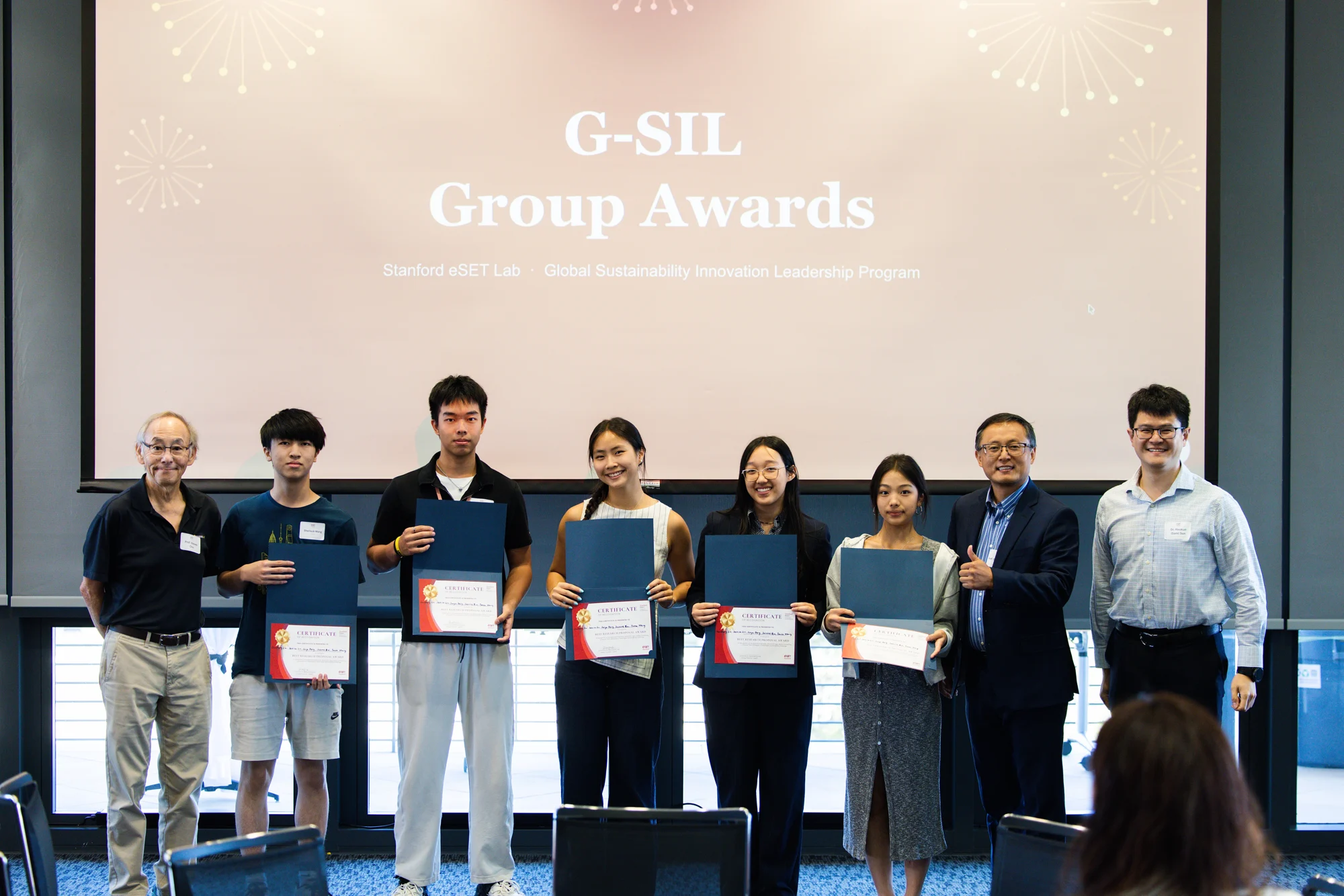 A student team and educators with certificates at the G-SIL awards ceremony